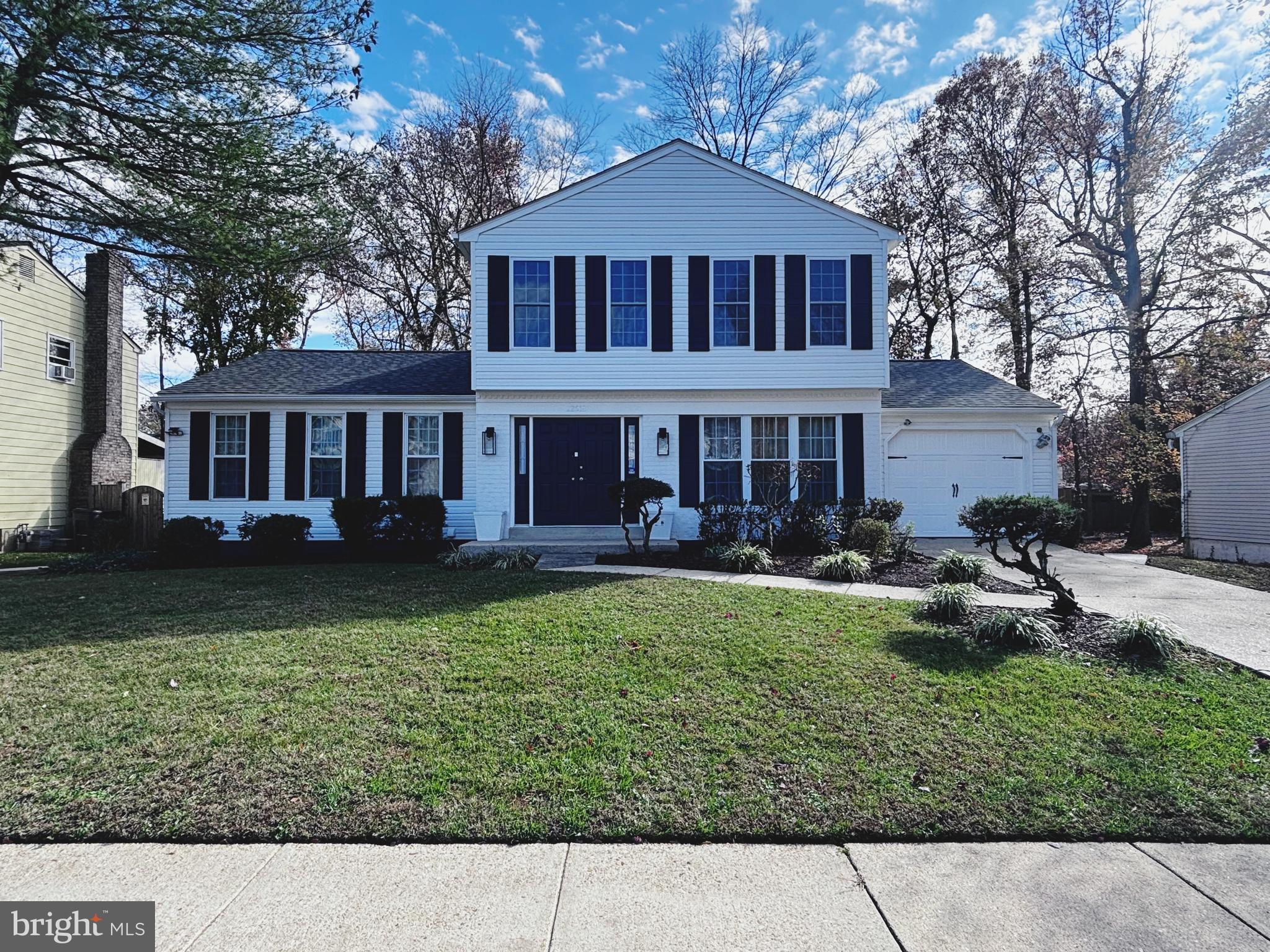 a front view of a house with a yard table and chairs