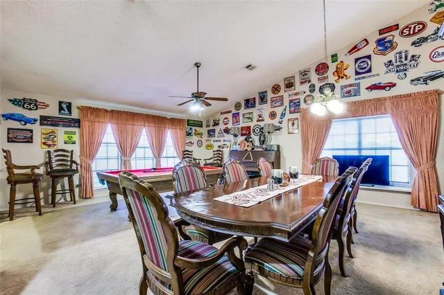 a view of a dining room with furniture and chandelier