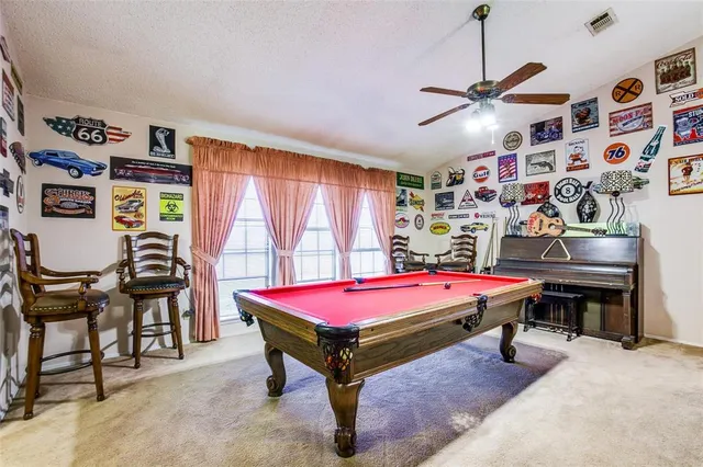 a room with furniture and pool table
