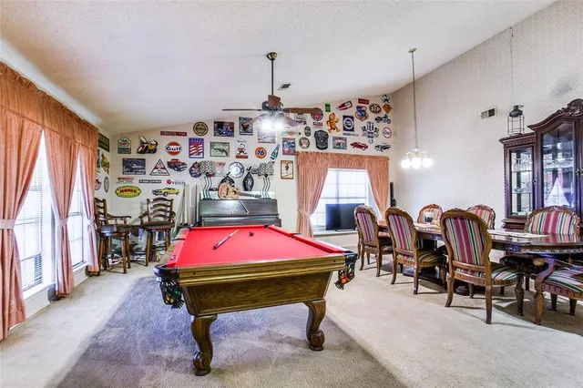 a dining room with furniture and chandelier
