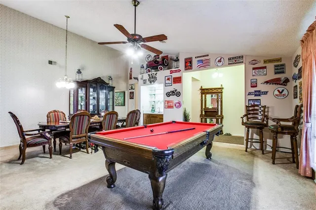 a dining room with furniture and chandelier