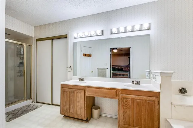 a bathroom with a sink double vanity and a mirror