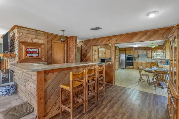 a dining room with furniture and wooden floor