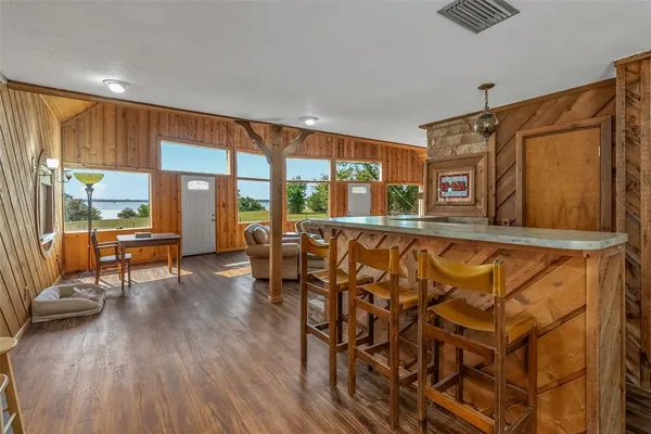 a living room with furniture and a floor to ceiling window