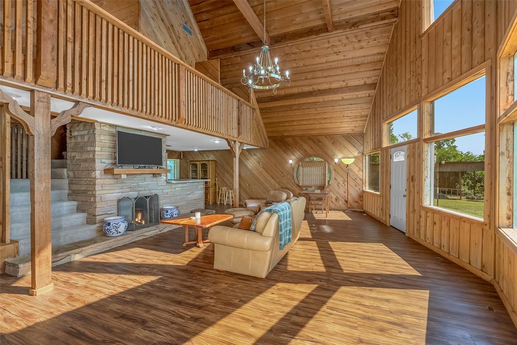 10307 Pirogue Road Oil City, LA 71061 - Photo 15 of 39 a view of a patio with dining table and chairs with wooden floor and fence