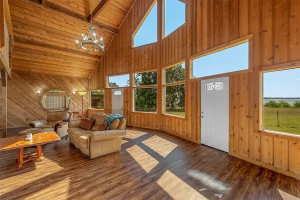 a view of living room with patio furniture and floor to ceiling window