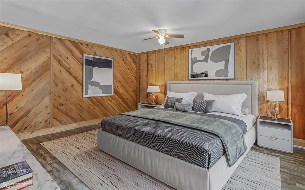 10307 Pirogue Road Oil City, LA 71061 - Photo 21 of 39 a bedroom with a bed and wooden floor
