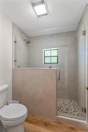 a bathroom with a toilet and a shower