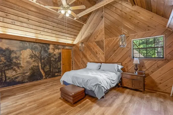 a bedroom with a bed couch and a window