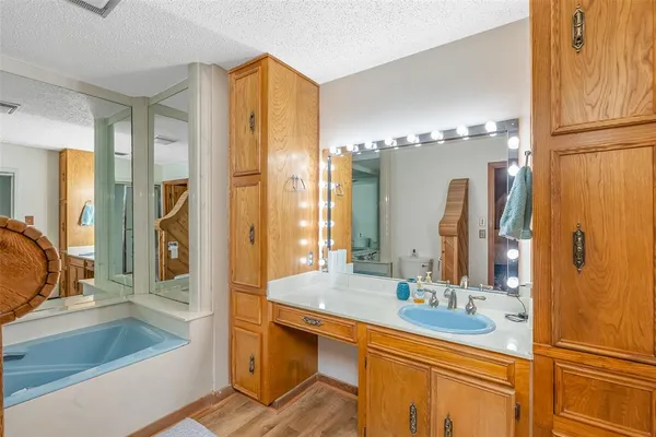 a bathroom with a double vanity sink mirror and shower