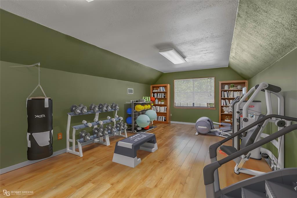 10307 Pirogue Road Oil City, LA 71061 - Photo 36 of 39 a bedroom with furniture and a wooden floor