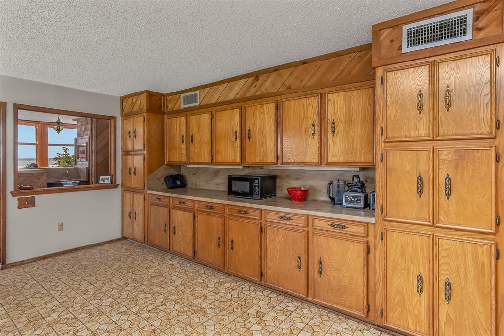 10307 Pirogue Road Oil City, LA 71061 - Photo 8 of 39 a kitchen with white cabinets and white appliances
