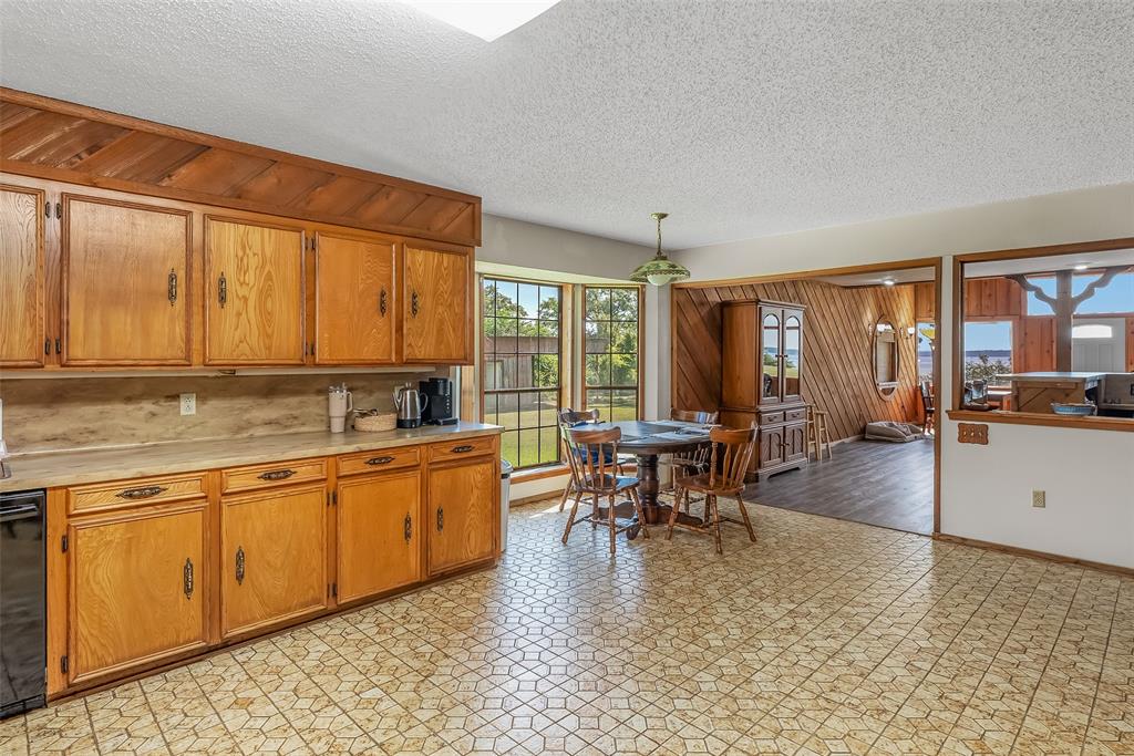 10307 Pirogue Road Oil City, LA 71061 - Photo 9 of 39 a dining hall with stainless steel appliances granite countertop a stove a sink a dining table and chairs with wooden floor