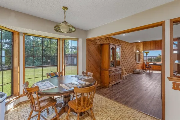 a view of a dining room with furniture window and outside view
