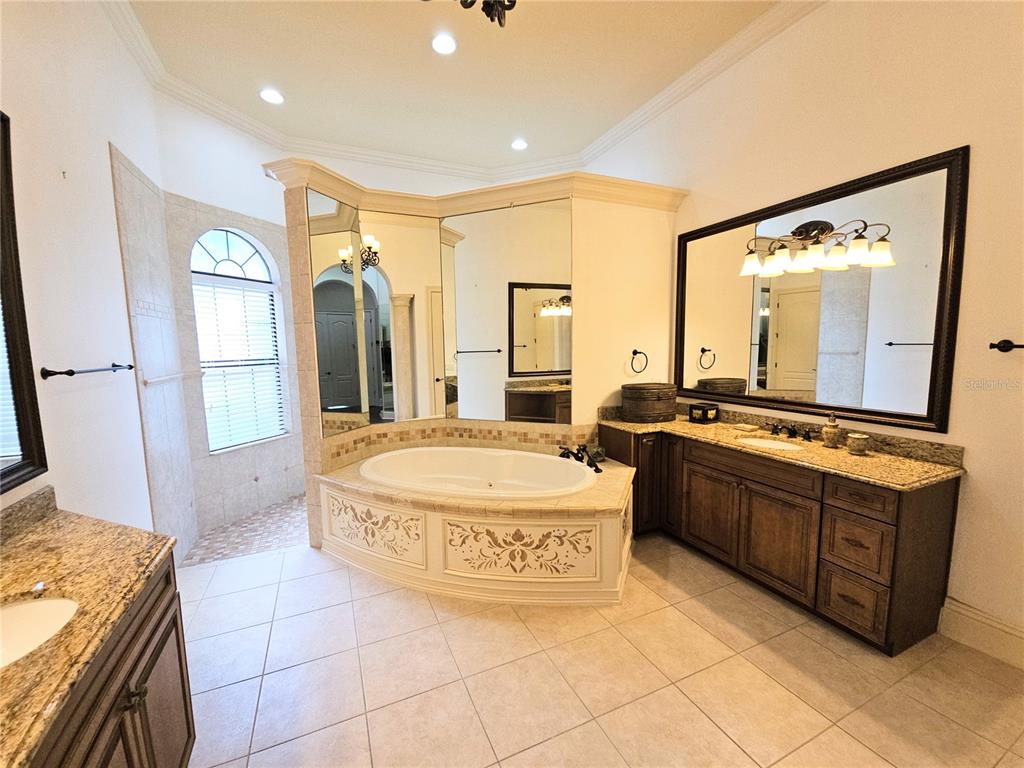 420 Muirfield Loop Reunion, FL 34747 - Photo 23 of 60 a spacious bathroom with a double vanity sink and a mirror