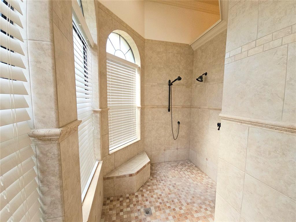 420 Muirfield Loop Reunion, FL 34747 - Photo 25 of 60 a bathroom with a granite countertop shower and a toilet