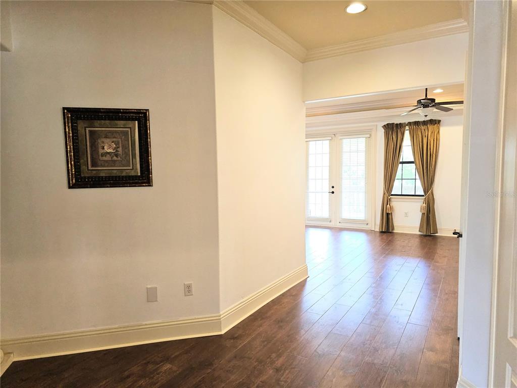 420 Muirfield Loop Reunion, FL 34747 - Photo 33 of 60 an empty room with wooden floor and windows