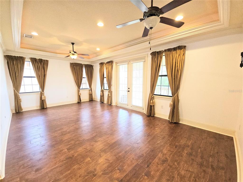 420 Muirfield Loop Reunion, FL 34747 - Photo 34 of 60 a view of an empty room with wooden floor and a window