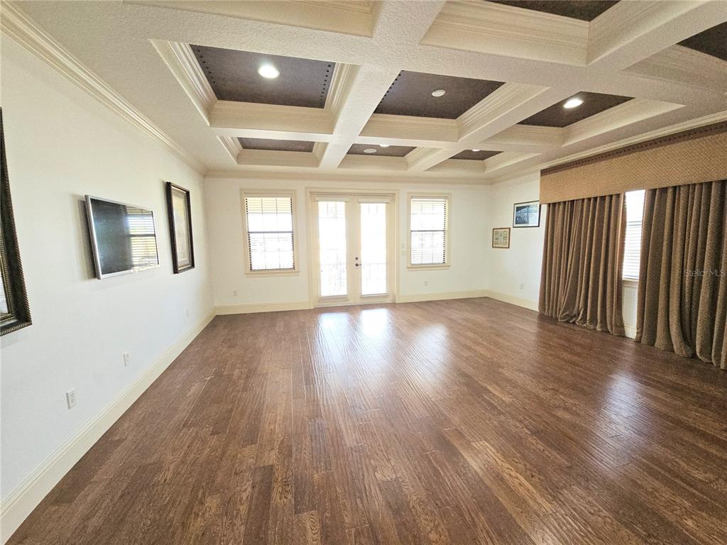 420 Muirfield Loop Reunion, FL 34747 - Photo 44 of 60 a view of an empty room with wooden floor and a window