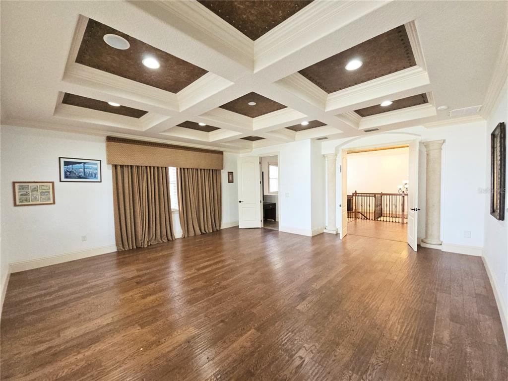 420 Muirfield Loop Reunion, FL 34747 - Photo 45 of 60 a view of an empty room with wooden floor and a window