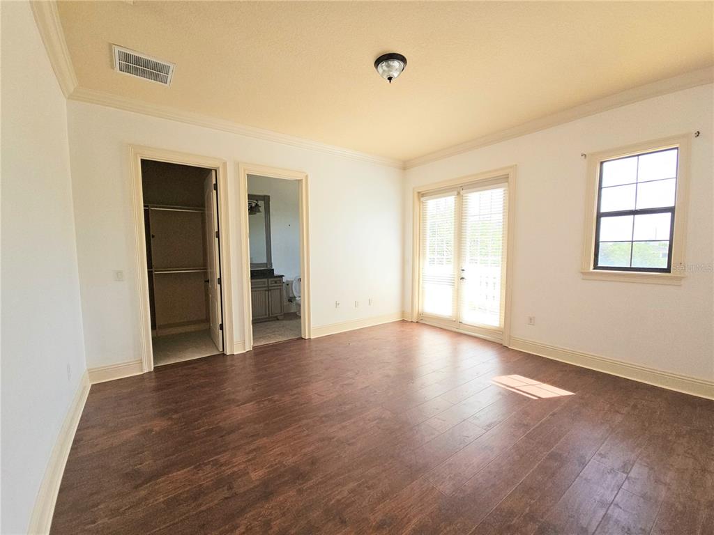 420 Muirfield Loop Reunion, FL 34747 - Photo 53 of 60 an empty room with wooden floor and windows