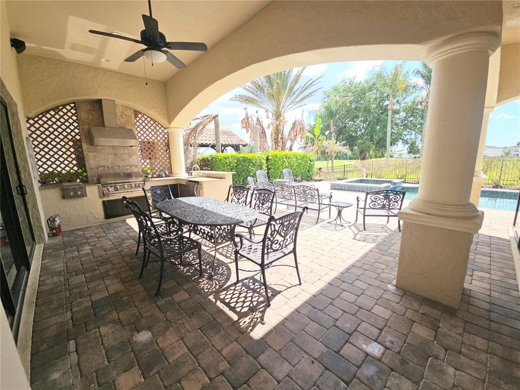 420 Muirfield Loop Reunion, FL 34747 - Photo 55 of 60 a view of a dining room with furniture wooden floor and a rug