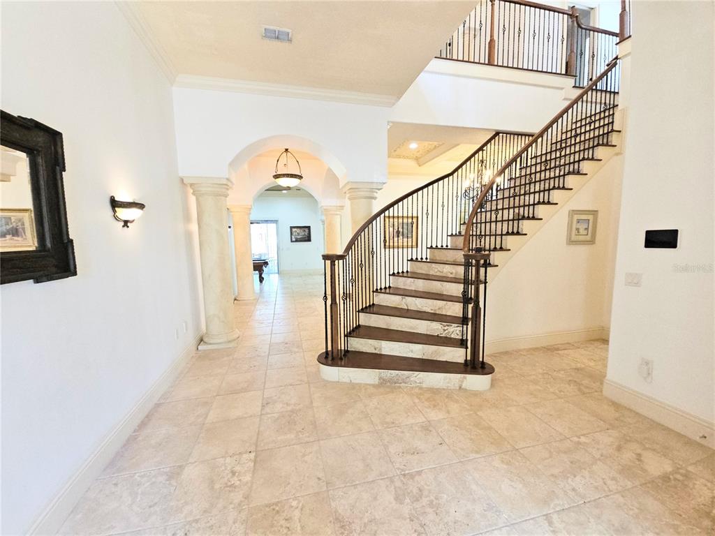 420 Muirfield Loop Reunion, FL 34747 - Photo 7 of 60 a view of entryway and hall with wooden floor