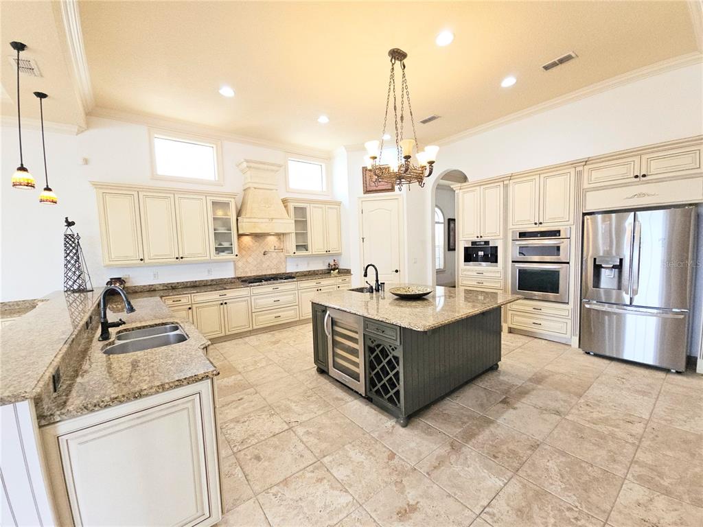 420 Muirfield Loop Reunion, FL 34747 - Photo 9 of 60 a large white kitchen with stainless steel appliances