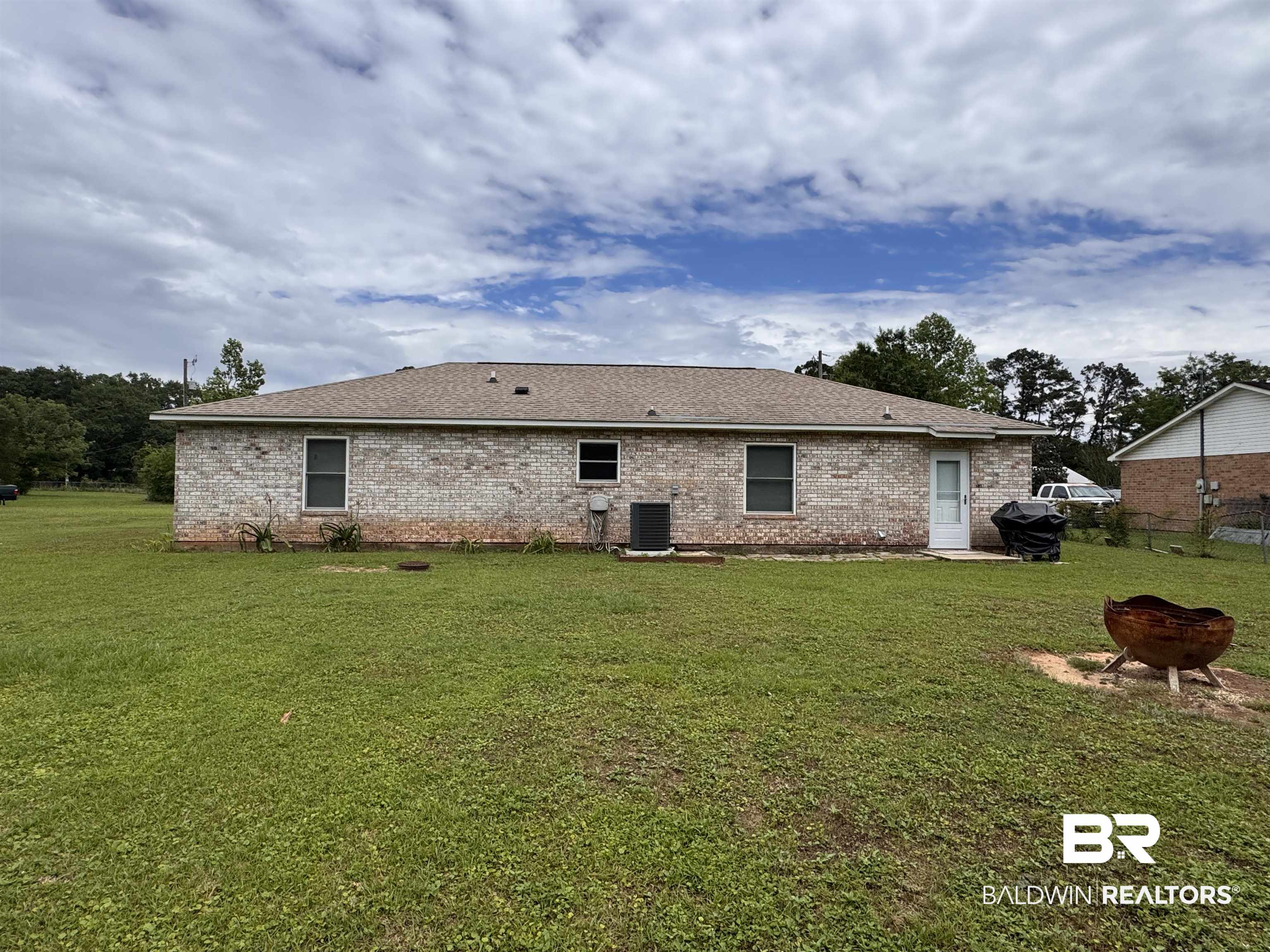 15148 Highland Circle Foley, AL 36535 - Photo 5 of 47 Back of house featuring brick siding, a fire pit, a shingled roof, and central air condition unit