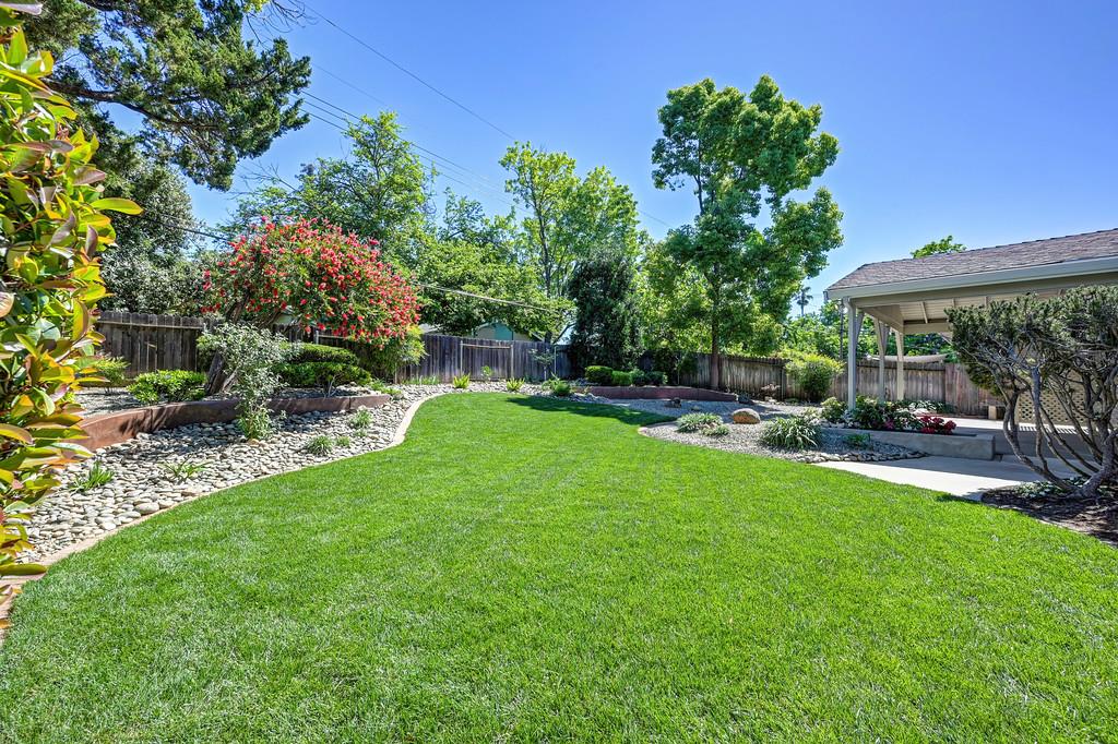 5824 Hesper Way Carmichael, CA 95608 - Photo 20 of 56 a view of a patio with a table and chairs under an umbrella
