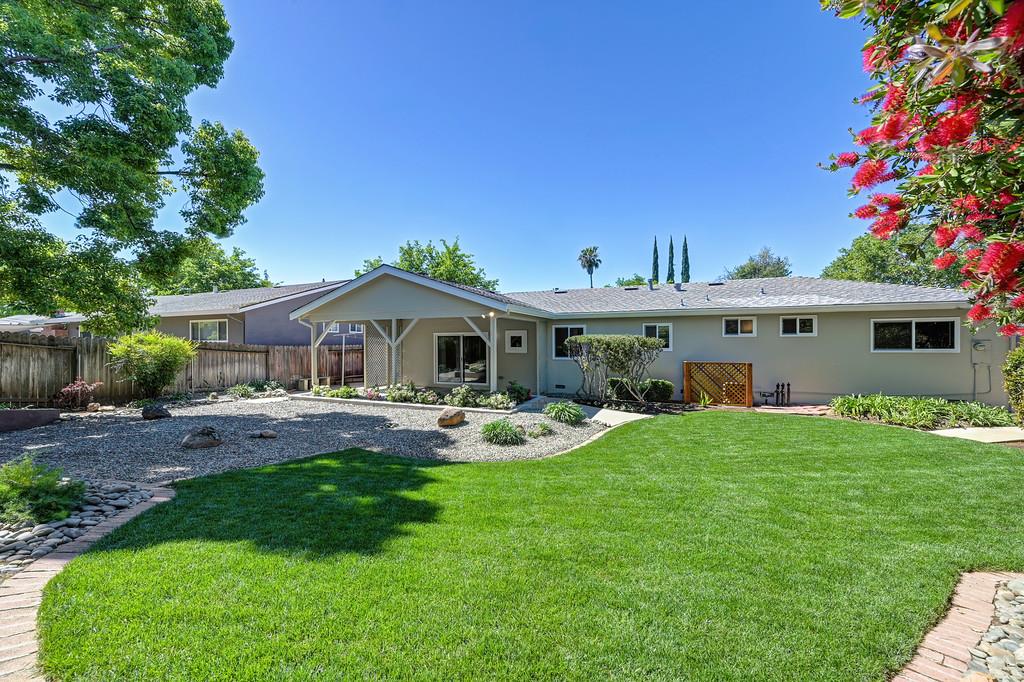 5824 Hesper Way Carmichael, CA 95608 - Photo 21 of 56 a front view of a house with garden and trees