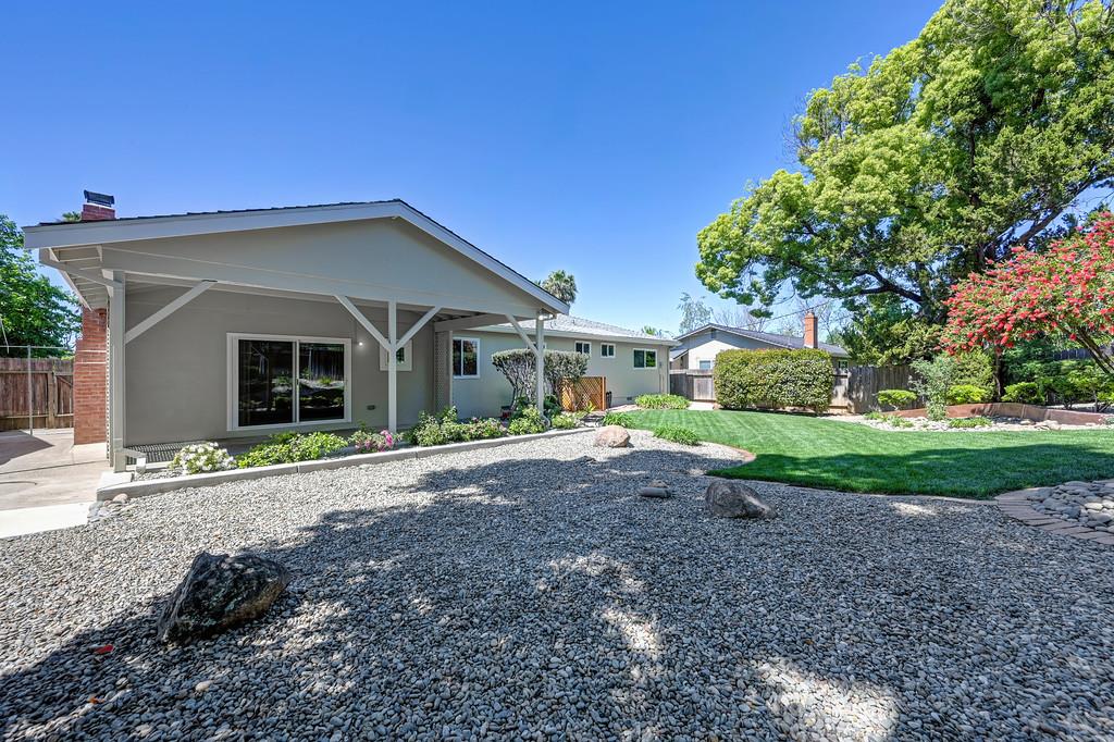 5824 Hesper Way Carmichael, CA 95608 - Photo 23 of 56 a front view of a house with a yard and potted plants
