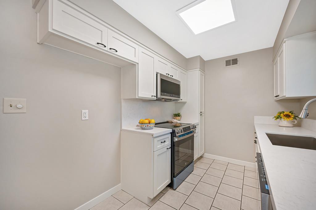 5824 Hesper Way Carmichael, CA 95608 - Photo 33 of 56 a kitchen with stainless steel appliances a sink a stove top oven a counter space and cabinets