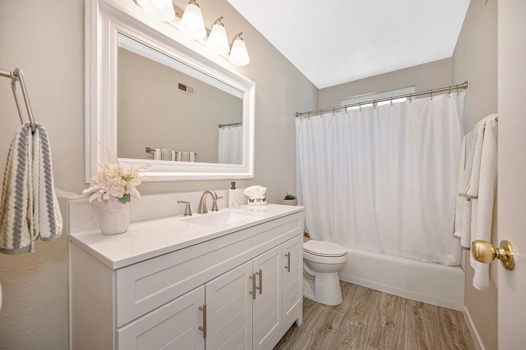 5824 Hesper Way Carmichael, CA 95608 - Photo 43 of 56 a bathroom with a sink a toilet a mirror a vanity and shower