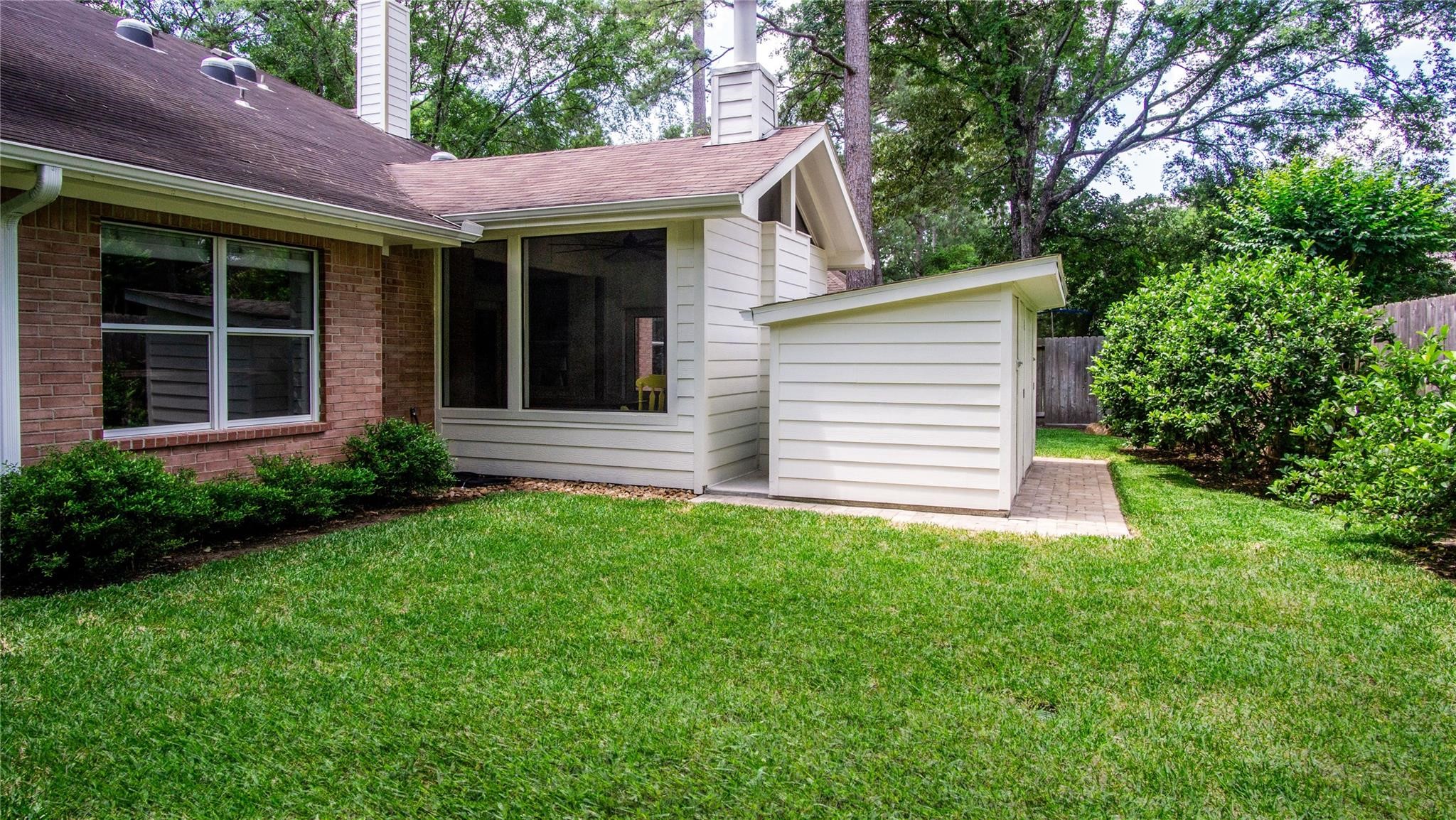 10 Belcarra Place Spring, TX 77382 - Photo 42 of 49 Another view of the huge storage shed just beyond the enclosed patio room providing so much storage for lawn equipment, gardening supplies or bikes! Recently removed Trampoline so grass is recovering