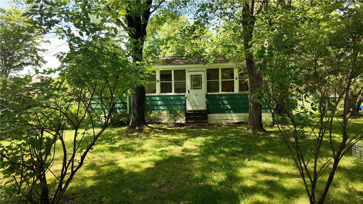 View of outbuilding featuring a lawn