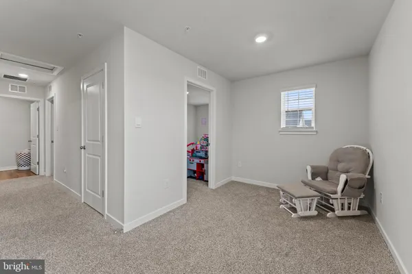 a view of a room with gym equipment and windows