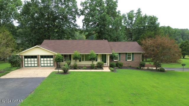 a front view of a house with a garden and yard