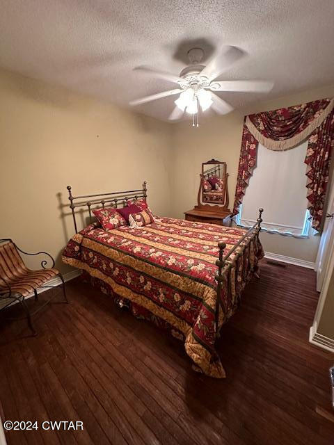 591 Asbury Road Camden, TN 38320 - Photo 15 of 38 a bedroom with a bed and wooden floor