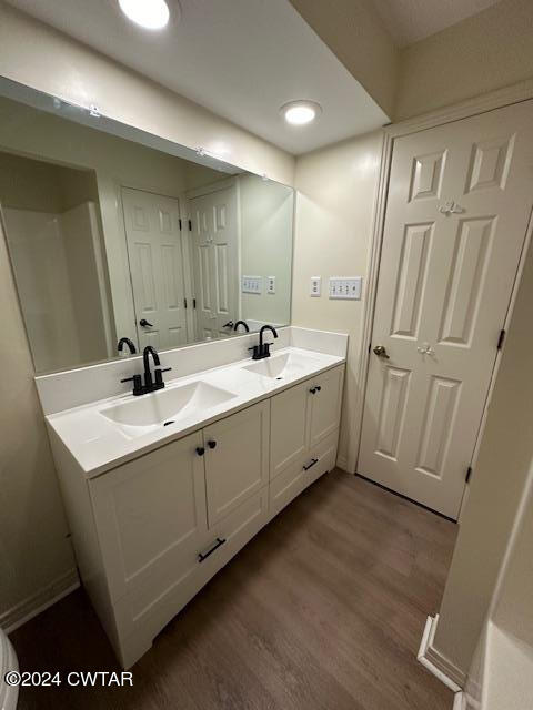 591 Asbury Road Camden, TN 38320 - Photo 16 of 38 a bathroom with a double vanity sink and mirror