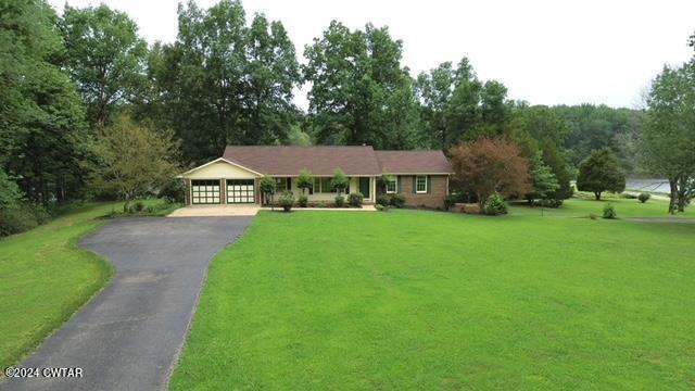 591 Asbury Road Camden, TN 38320 - Photo 2 of 38 a view of house with garden and trees