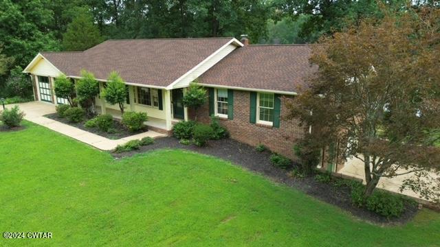 591 Asbury Road Camden, TN 38320 - Photo 28 of 38 a view of house with garden and a sitting area