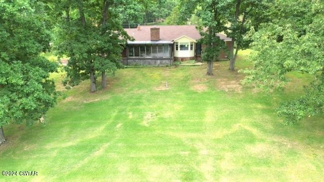 591 Asbury Road Camden, TN 38320 - Photo 34 of 38 a view of a house with a yard and sitting area