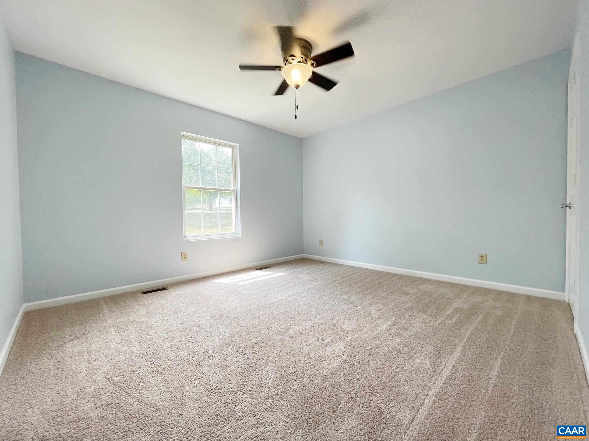81 Phlox Road Ruckersville, VA 22968 - Photo 12 of 24 an empty room with a ceiling fan and window