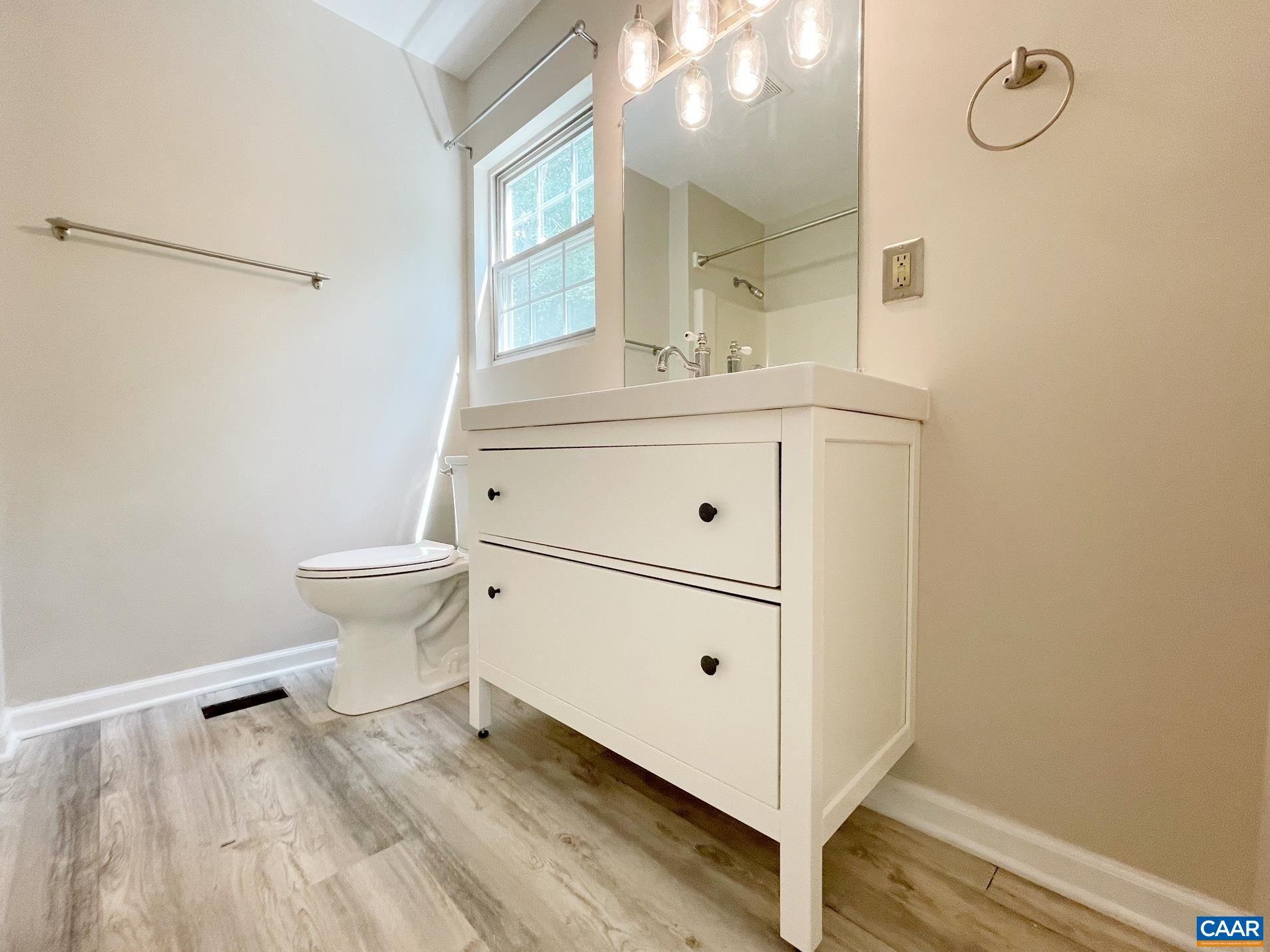 81 Phlox Road Ruckersville, VA 22968 - Photo 15 of 24 a bathroom with a sink mirror vanity and toilet