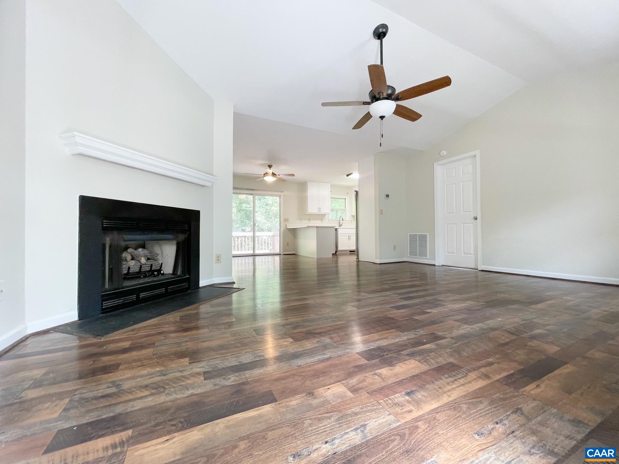 81 Phlox Road Ruckersville, VA 22968 - Photo 3 of 24 a view of an empty room with a fireplace and a fan