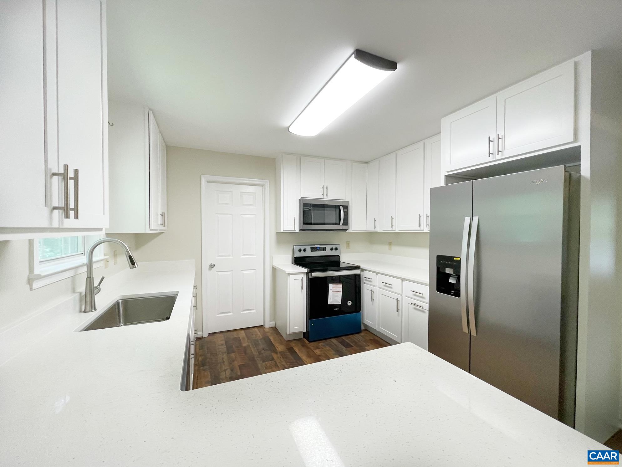 81 Phlox Road Ruckersville, VA 22968 - Photo 7 of 24 a kitchen with granite countertop a refrigerator stove and kitchen island