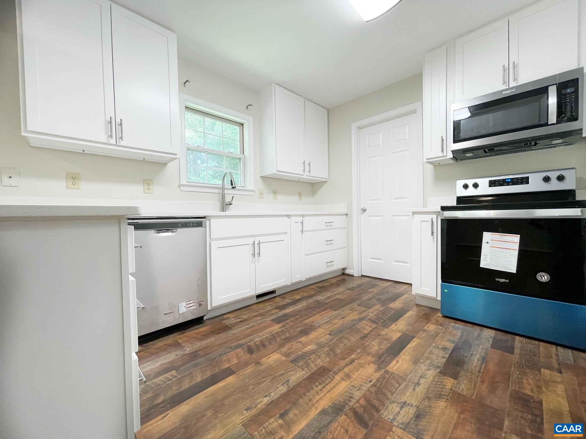 81 Phlox Road Ruckersville, VA 22968 - Photo 8 of 24 a kitchen with stainless steel appliances granite countertop a stove a sink and a microwave