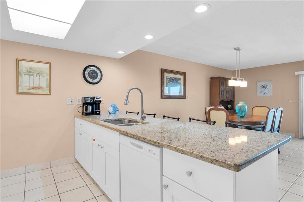 19610 Gulf Boulevard, Unit 308 Indian Rocks Beach, FL 33785 - Photo 12 of 41 a kitchen with a sink and a stove top oven