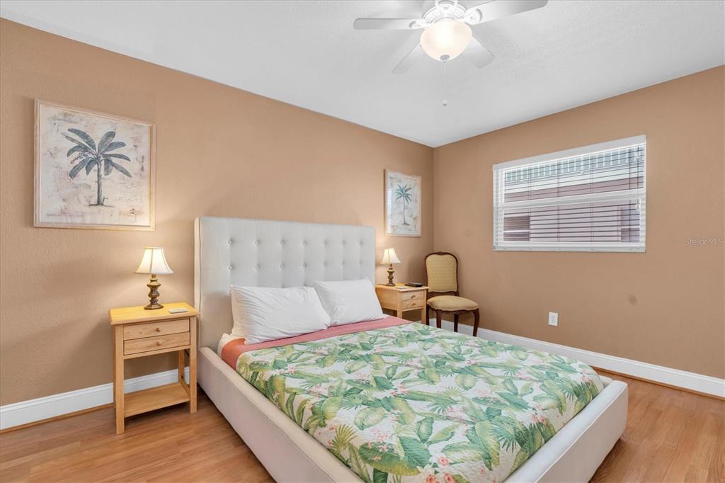 19610 Gulf Boulevard, Unit 308 Indian Rocks Beach, FL 33785 - Photo 17 of 41 a bedroom with a bed and a chandelier